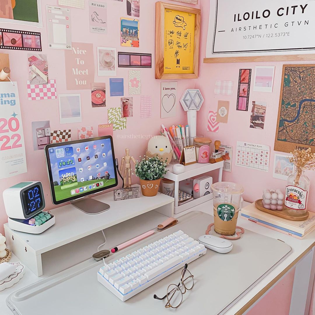 Chic workspace displaying a Royal Kludge RK61 keyboard, a laptop, and organized stationery against a soft backdrop