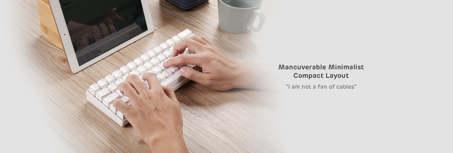 Person typing on the Royal Kludge RK61 60% keyboard in a minimalist setup, showcasing its compact and maneuverable design, ideal for cable-free use