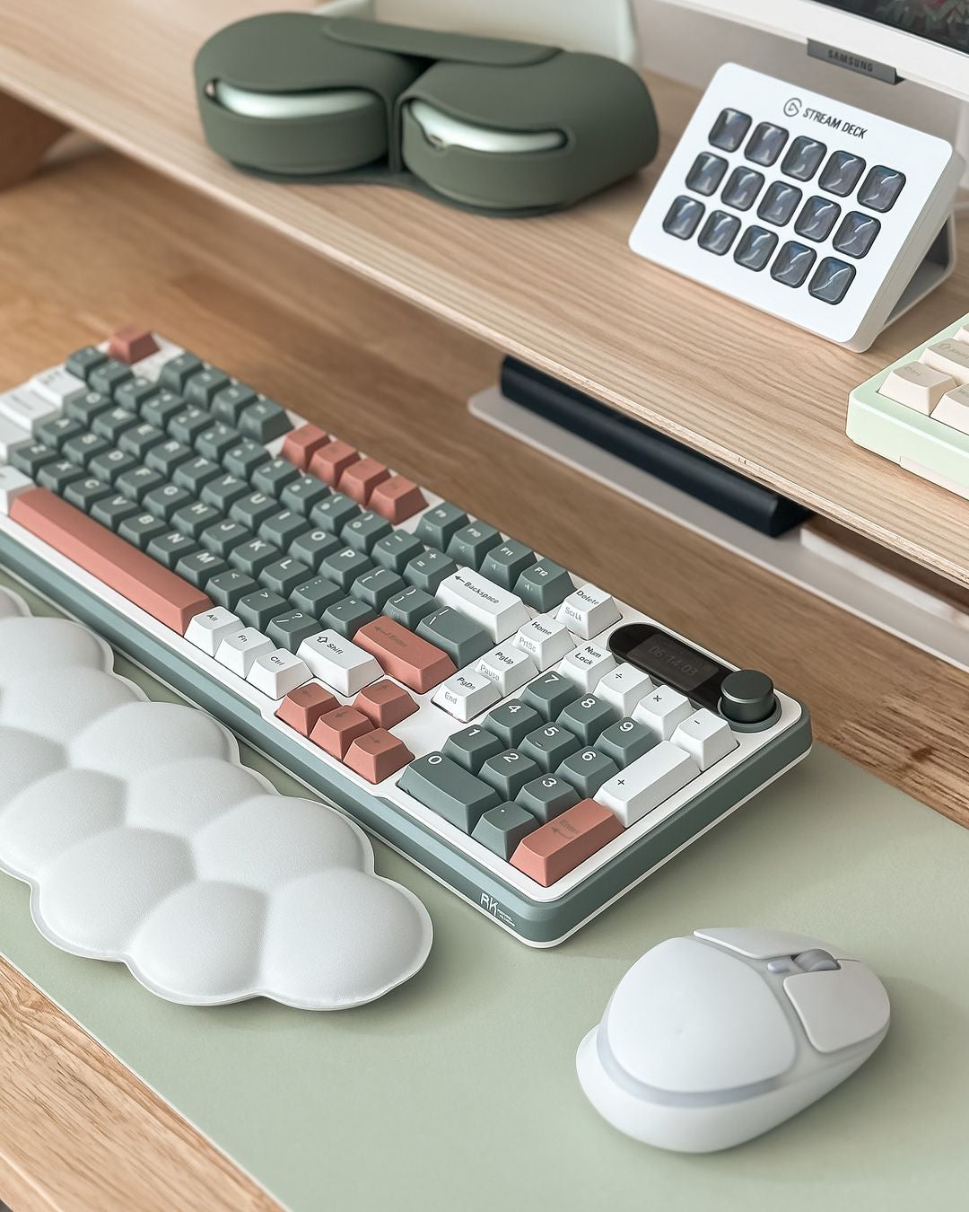 S98 keyboard displayed on a wooden desk with a modern design, featuring green and peach keycaps, alongside a calculator and other accessories