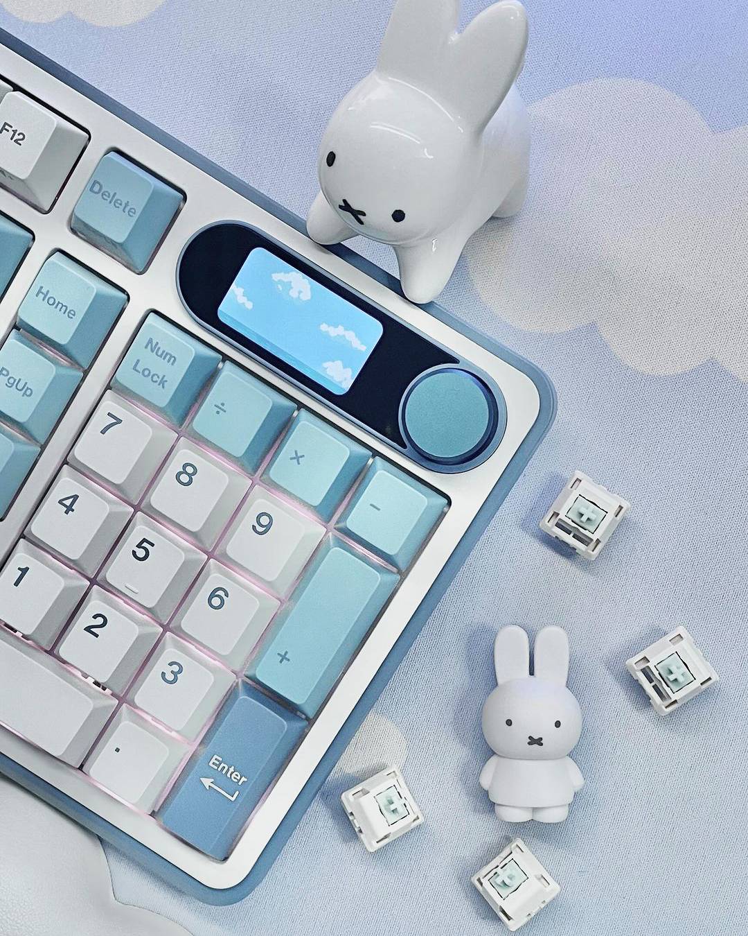 Royal Kludge S98 hot swappable gaming keyboard featuring a digital display, surrounded by cute decorative items like bunny figures and pastel-colored keycaps