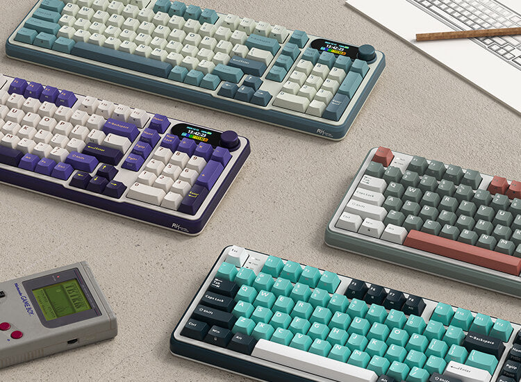Variety of Royal Kludge S98 keyboards in different color schemes arranged on a desk, showcasing their stylish designs and features alongside a sketch and decorative plant